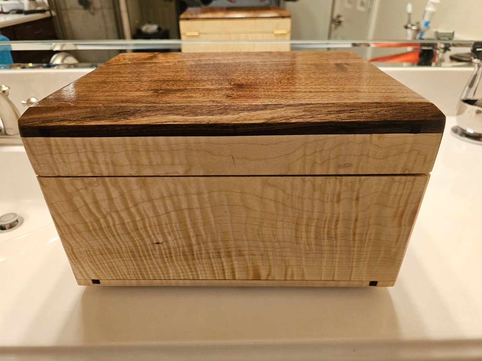 Handmade keepsake box with figured maple body, walnut lid, and dovetail joinery with contrasting splines